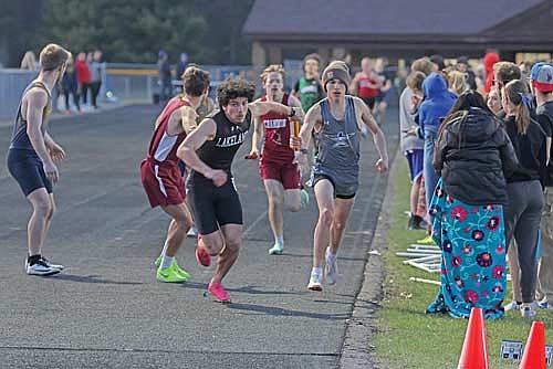 Justin Funmaker hands the baton off to Ethan Gonzalez in the 4x400-meter relay during the Eagle Relays Thursday, April 25 at Northland Pines High School in Eagle River. The Thunderbirds won the event with a time of 3:39.71. (Photo by Jeremy Mayo/River News)