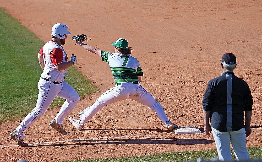 Rhinelander’s Barak Rappley stretches at first base to field a throw and retire Medford’s Max Dietzman during the first inning of a GNC baseball game at Stafford Field Thursday, April 25. (Bob Mainhardt for the River News)