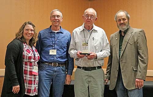 Virgil Davis (center right) and Joe Priebe (center left) received the Club of the Year award from the Wisconsin Wildlife Federation at the Federation’s annual banquet this month. The award was presented by Federation president Connie Polzin (left) and past president Kevyn Quamme (right). (Photo by Beckie Gaskill/Lakeland Times)