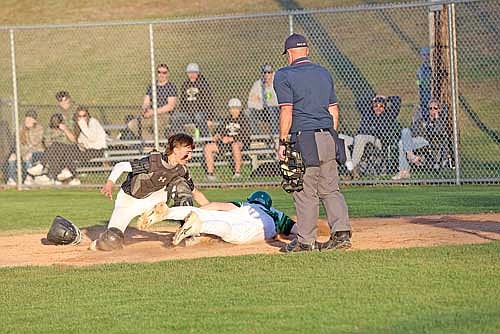 Ashton Bremer looks to tag out Rhinelander’s Kaden Vanney during the second game of a doubleheader Friday, May 3 at Stafford Field in Rhinelander. (Photo by Bob Mainhardt/for the River News)