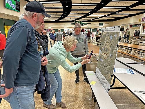 Stella residents study a map showing the new PFAS testing radius during an informational meeting Wednesday, May 1, 2024 in Rhinelander. (Photo by Heather Schaefer/River News)