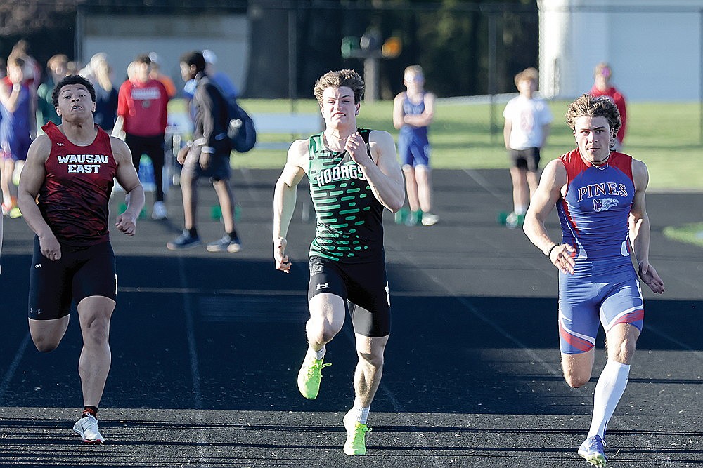 Rhinelander’s Zach Germain, center, races Northland Pines’ Eli Kerner, right, and Wausau East’s Ralph Pegues in the 100-meter dash during the Otto Bacher Invitational track meet in Merrill Friday, May 3. Germain finished second to Kerner in the event as the Hodags placed fourth in the meet. (Jeremy Mayo/River News)