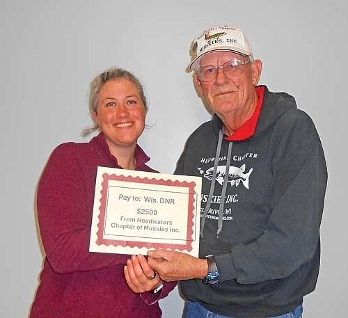 Headwaters grant writer Dale Peterson presents a $2,500 grant to Stephanie Shaw, DNR fish biologist at Escanaba Lake Research Center. (Contributed photograph)