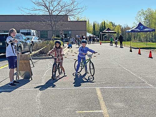 Young cyclists learn to “look both ways” while out on the road this summer. (Photo by Heather Schaefer/River News)