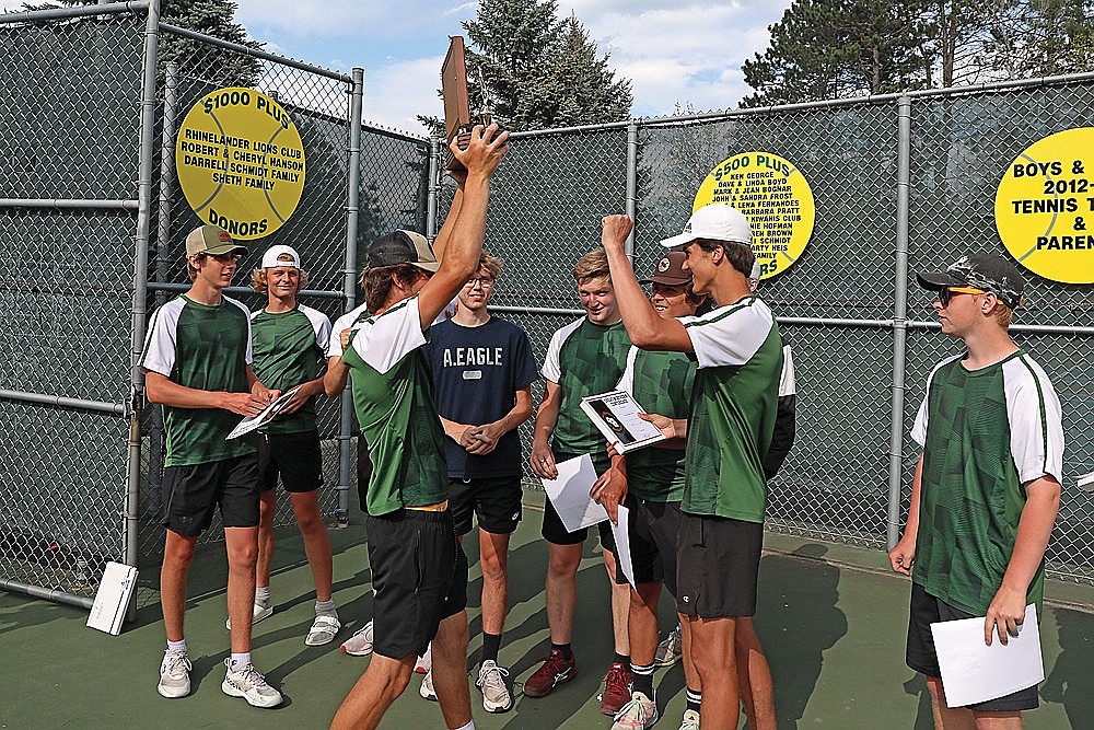 Rhinelander’s Joey Belanger delivers the Great Northern Conference championship trophy to his teammates following the GNC boys’ tennis tournament at the RHS tennis courts Friday, May 17. The Hodags claimed their 10th straight GNC title, and 12 conference championship in the last 13 seasons. (Bob Mainhardt for the River News)