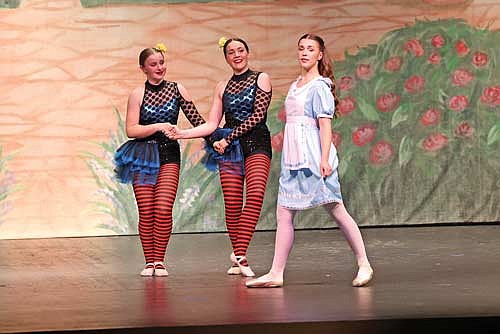 Tweedle Dum (Ella Stolzman) and Tweedle Dee (Ava Sadak), give Alice (Katelyn Shrock) no help in getting back to the river bank during the Northwoods School of Dance production of “Alice in Wonderland” at the John and Dori Brown Performing Arts Center Saturday, May 18, 2024. (Photo by Bob Mainhardt For the River News)