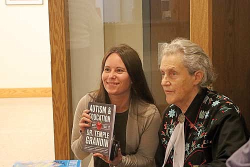 Quinn Novy takes a photo with Temple Grandin before her presentation at the Campanile Center for the Arts. (Photo by Kate Reichl/Lakeland Times)