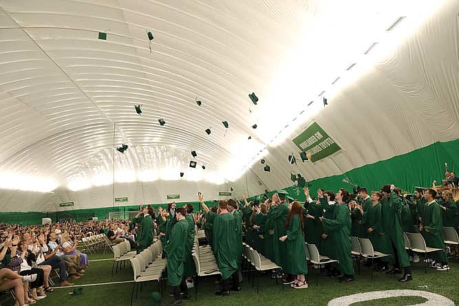 Members of the Rhinelander High School Class of 2024 toss their caps into the air after being presented to the crowd following commencement exercises on Friday evening, May 31, 2024 at the Hodag Dome. (Photo by Bob Mainhardt for the River News)