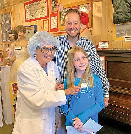 Bonnie Butzer as “Dr. Kate”checks on third-grader Jordan Thielman’s heart, as Chris Thielman looks on during a visit to the Dr. Kate Museum in Woodruff. (Contributed photograph)