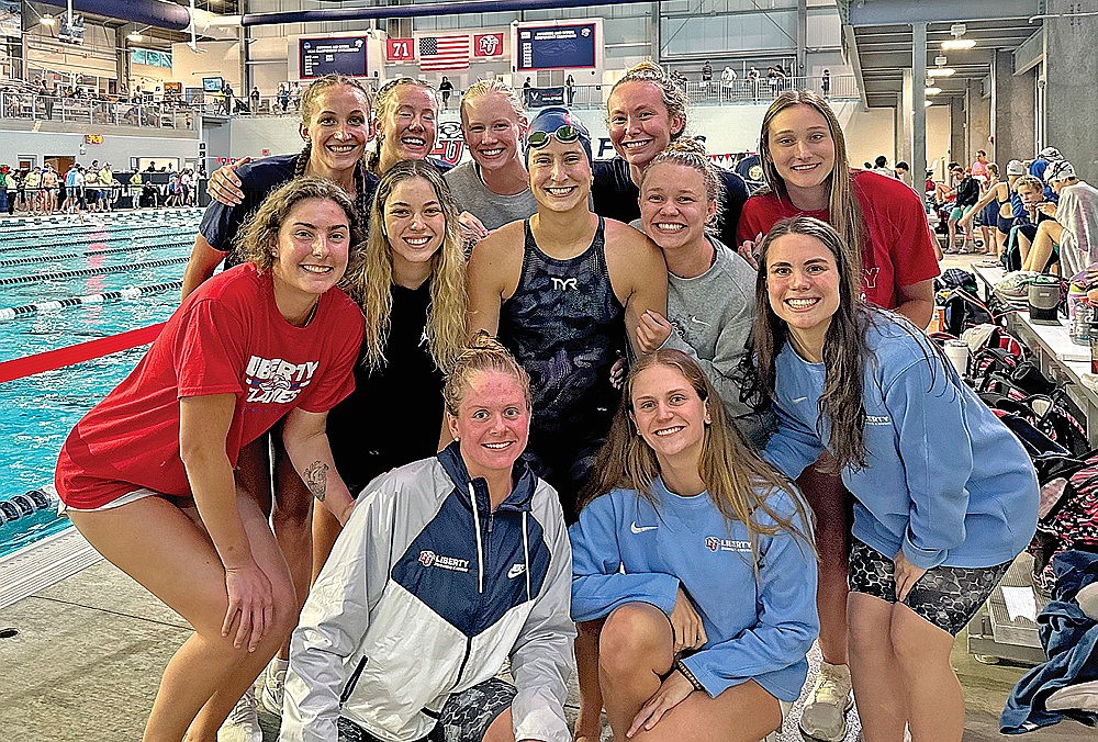 Rhinelander native Malia Francis, center, is surrounded by Liberty University teammates after Francis qualified for the U.S. Olympic Trails during the Virginia Commonwealth Games in Lynchburg, Va. Sunday, June 2. Francis qualified in the 200-meter backstroke and will compete Thursday, June 20 at the U.S. Olympic Trials in Indianapolis. (Submitted photo)