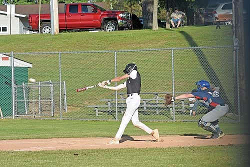 Ashton Bremer hits an RBI double to center in the third inning against Merrill during the opening game of the Rebel Invite Friday, June 14 at Stafford Field in Rhinelander. (Photo by Brett LaBore/Lakeland Times)