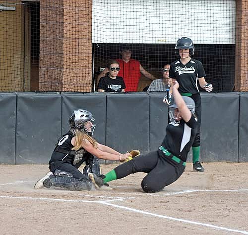 Lucy Henn tags out a Rhinelander runner at the plate during the first inning Tuesday, June 18 at Lenz Field in Minocqua. (Photo by Brett LaBore/Lakeland Times)