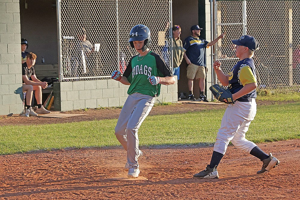 Rhinelander’s Jaxon West scores on a passed ball during the sixth inning of a Northwoods Babe Ruth Prep League game at Tomahawk Wednesday, June 26. The Hodags scored seven times in the sixth inning as they defeated the previously unbeaten Hatchets, 15-5. (Jeremy Mayo/River News)