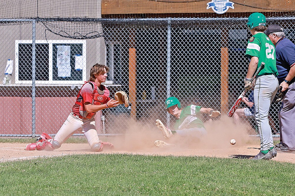 Rhinelander’s Seth Nofftz beats a throw to the plate as he steals home during the sixth inning of an American Legion baseball game against Altoona in Merrill Sunday, June 30. The Rebels defeated the Reds 7-3 to move back to .500 on the season. (Bob Mainhardt for the River News)