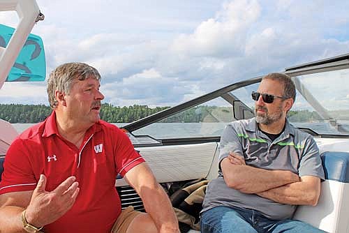 State representative Rob Swearingen (R-Rhinelander), left, speaks with Oneida County sheriff Grady Hartman during a wake boat demonstration on Thursday, June 27, on Lake Minocqua. (Photo by Trevor Greene/Lakeland Times)