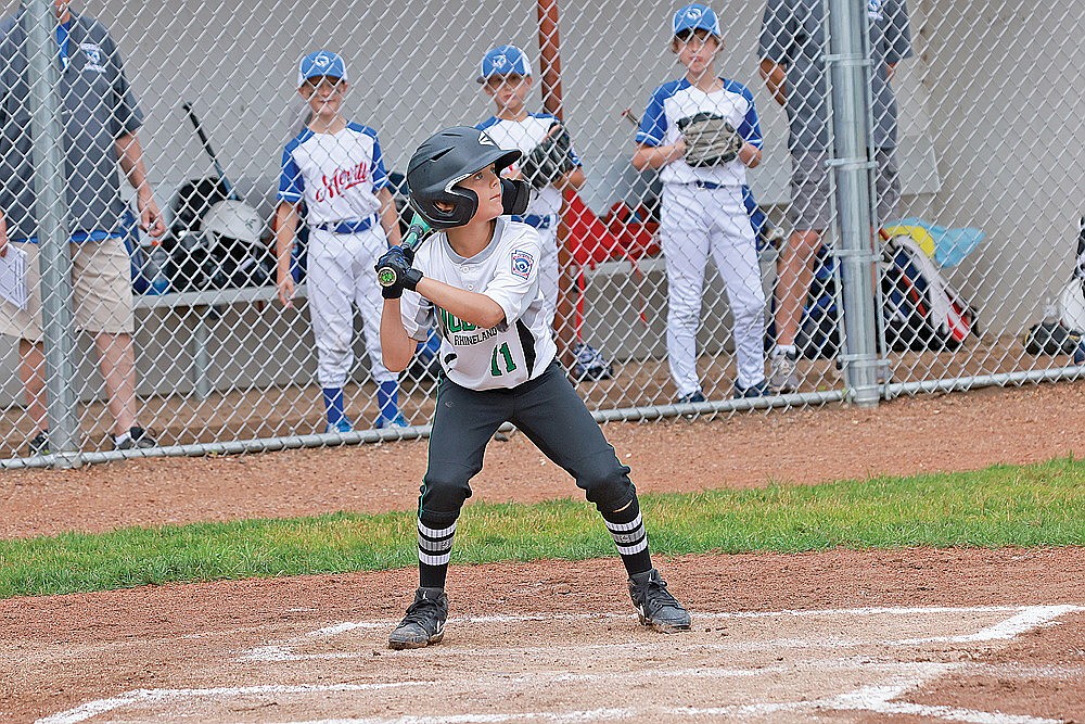 Colt Waksmonski takes a high pitch for a ball during a game against Merrill Monday, July 8. (Bob Mainhardt for the River News)