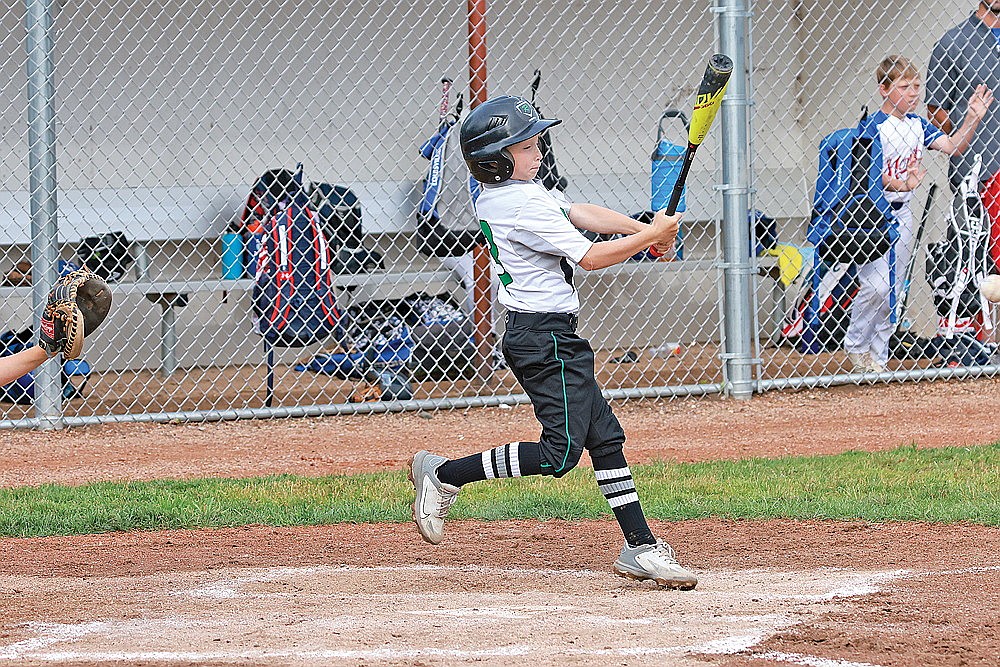 Braxton Bolkema hits a single during a game against Merrill Monday, July 8. (Bob Mainhardt for the River News)