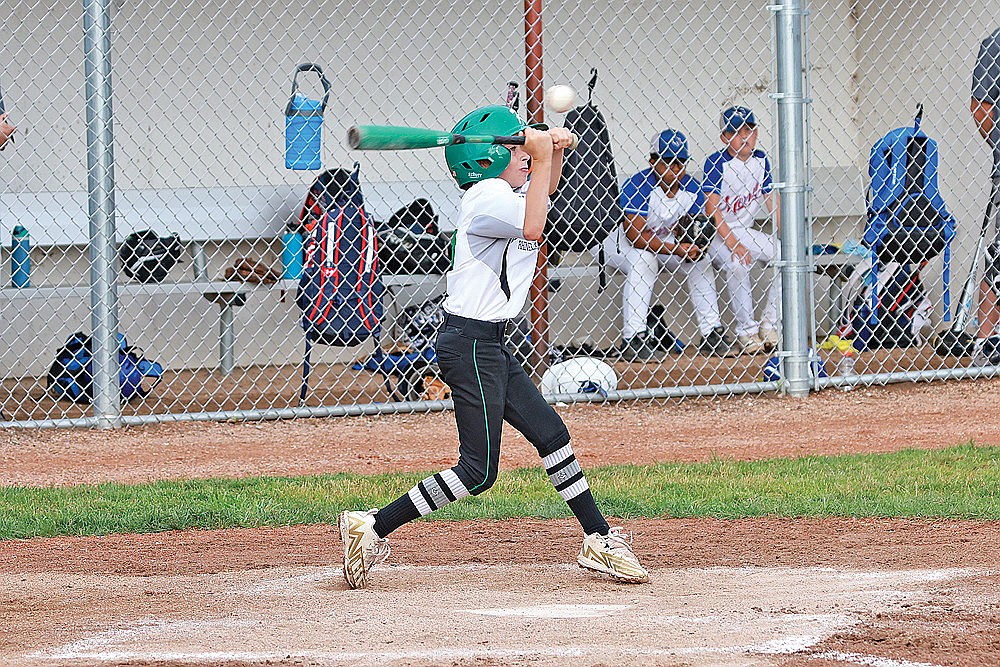 Mason Paulson tries to check his swing on a high pitch during a game against Merrill Monday, July 8. (Bob Mainhardt for the River News)