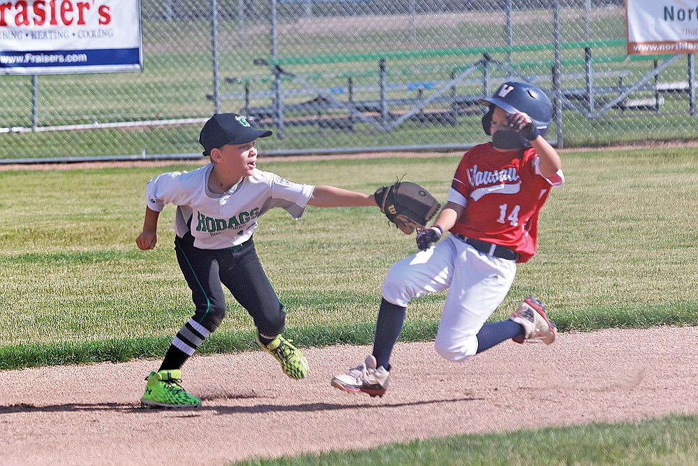 Easton Rady tags out a Wausau American runner Tuesday, July 9. (Bob Mainhardt for the River News)