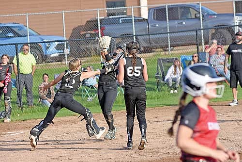 Zia Amershek, left, and Adalyn Bohne, middle, attempt to catch a pop-up in the infield with Britta Kemnitz (65) watching in the sixth inning against Crandon Monday, July 8 at Lenz Field in Minocqua. Bohne made the catch. (Photo by Brett LaBore/Lakeland Times)