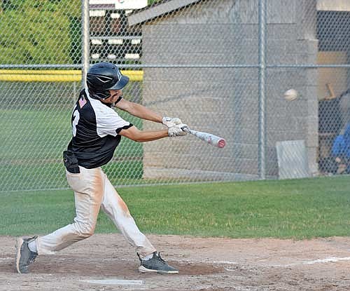 Logan Gray hits a two-run single to center in the sixth inning against Tomahawk Tuesday, July 9 at the Minocqua Park Complex. (Photo by Brett LaBore/Lakeland Times)