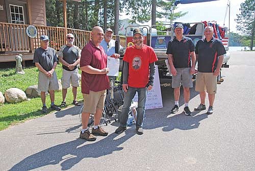 Camp American Legion received a 20-foot pontoon boat as a donation from Marine Corps veteran Kirk Schlenz of Manitowish Waters and his friend, Bob Larrabee of Rhinelander. Shown during the presentation on July 16 are, from left, David Larrabee, Bob Larrabee, camp director Jim Klement with the boat’s title, Darrell Kautch, Kirk Schlenz, Charlie Gahler and Larry Haling. (Photo by Brian Jopek/Lakeland Times)