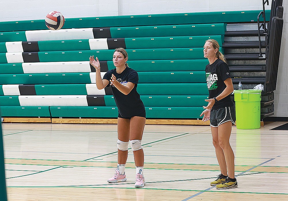 Rhinelander High School volleyball coach Jayme Wyss, right,  oversees senior-to-be Callie Hoerchler in a passing drill during Hodag Volleyball Camp Monday, July 22 at the Jim Miazga Community Gymnasium. (Bob Mainhardt for the River News)