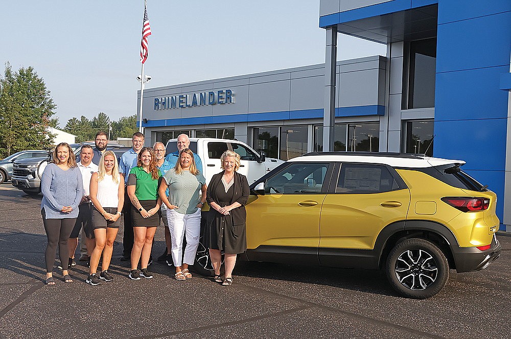 Pictured, standing next to the hole-in-one vehicle, are Rhinelander GM Digital Marketing specialist Miranda Gavrilescu, ABC board member Ali Shoeder, ABC board member Stefanie Edwards, ABC board member Amanda Jorata and Rhinelander GM Marketing Coordinator Tarsie Goes. In the second row are ABC board member Dave Mannikko and Rich Gilbert, Rhinelander GM used car manager. In the back row are ABC board member Jeremy McCone, ABC board president Brandon Karaba and Mike Boyd of Boyd Financial Services (Jeremy Mayo/River News)