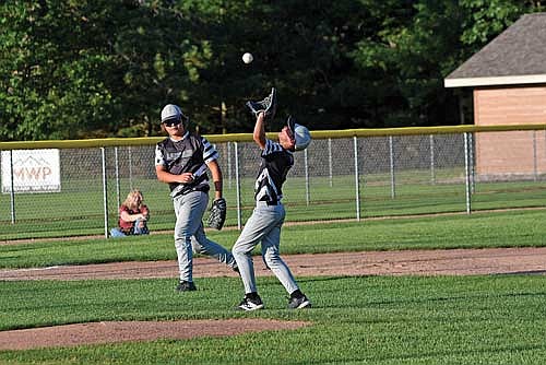 Levi Eslinger catches a pop-up with William Schuman looking on in the third inning against Tomahawk Wednesday, July 24 at the Minocqua Park Complex. (Photo by Brett LaBore/Lakeland Times)