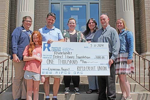 Pictured, from left to right, are Virginia Roberts, director of the Rhinelander District Library, Izzy Osness, Ransey Osness, president of the Rhinelander District Library Foundation, and Kaydee Mikalauski, Daisy Ortiz, Tony Mustacci and Nicole Brand with RIPCO Credit Union. (Submitted photos)