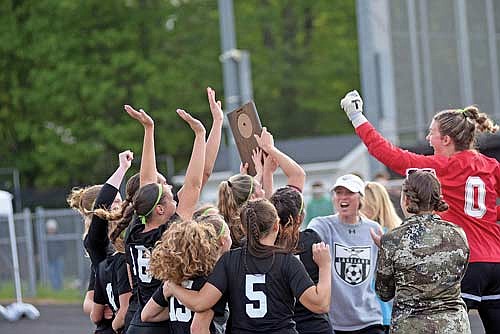 In this June 1, 2024 file photo, coach Stephanie Hartzheim, center, fires up the Thunderbirds as they lift up the plaque after beating Rhinelander 1-0 in a WIAA Division 3 regional final game at IncredibleBank Field in Minocqua. (Photo by Brett LaBore/Lakeland Times)