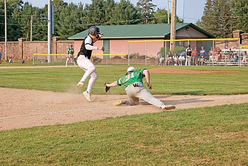 Merick Trotter looks to avoid the tag of Rhinelander’s Tyler Chariton in a Class AA Region 2 Tournament game Friday, July 26 at Athletic Park in Merrill. (Photo by Bob Mainhardt for the River News)