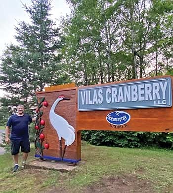 Chad Laibly restored a 12-foot by 8-foot, 500-pound sign with a sandhill crane, one originally made by his father, for Vilas Cranberry in Manitowish Waters. (Contributed photograph)