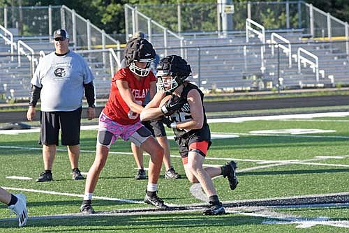 Deklan McQuade hands the ball off to Justin Baird during the first day of practice Tuesday, Aug. 6 at IncredibleBank Field in Minocqua. (Photo by Brett LaBore/Lakeland Times)