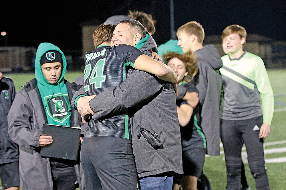 In this Oct. 29, 2022 file photo, Nathan Bates hugs Rhinelander High School boys’ soccer player Charlie Heck after the Hodags defeated Rice Lake in a WIAA Division 3 sectional final game in Rice Lake. Bates, who stepped aside from the boys’ team following a run to the WIAA state tournament in 2022, is returning to the sideline this fall, both he and RHS activities director Brian Paulson confirmed to the River News. (Bob Mainhardt for the River News)