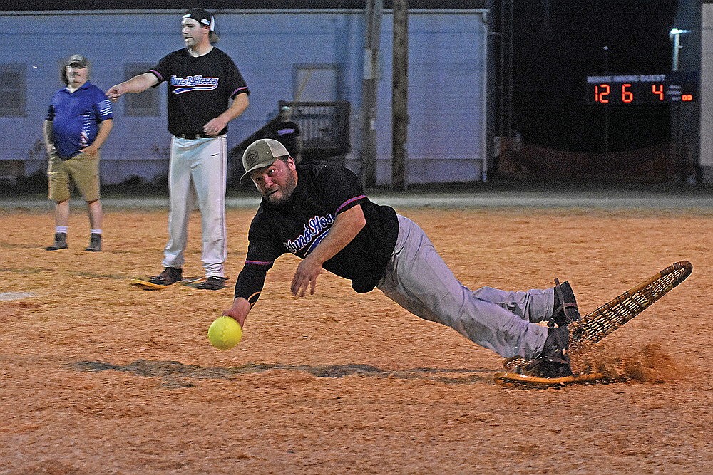 Ryan Schowalter of the local police/fire department tosses the ball to first base to get the out in the sixth inning Monday, Aug. 12 at Snowshoe Park in Lake Tomahawk. (Brett LaBore/Lakeland Times)