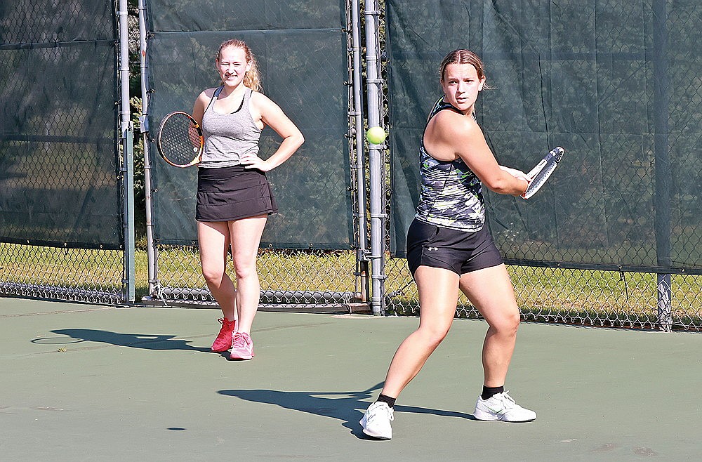 Kelsey Winter hit a ball while teammate Evelyn Sawyer looks on during Rhinelander High School girls’ tennis practice at the RHS tennis courts Tuesday, Aug. 13. Winter, who missed almost all of 2023 with a knee injury, is set to vie for the top spot in the singles lineup for the Hodags this fall. (Bob Mainhardt for the River News)