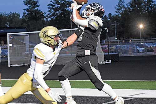 Merick Trotter catches a touchdown pass against the defense of Hayward’s Kyle Gajewski in the second quarter of Lakeland’s 24-3 season-opening win Friday, Aug. 23 at IncredibleBank Field in Minocqua. It was the first time Lakeland had won their season opener since 2019. (Photo by Brett LaBore/Lakeland Times)