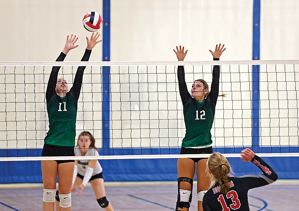 Rhinelander’s Kelsi Beran (11) and Callie Hoerchler (12) put up a block during a volleyball scrimmage against Prentice at Northland Pines High School in Eagle River Saturday, Aug. 24. Beran and Hoerchler are two of six returning players for the Hodag volleyball team this year. (Bob Mainhardt for the River News)