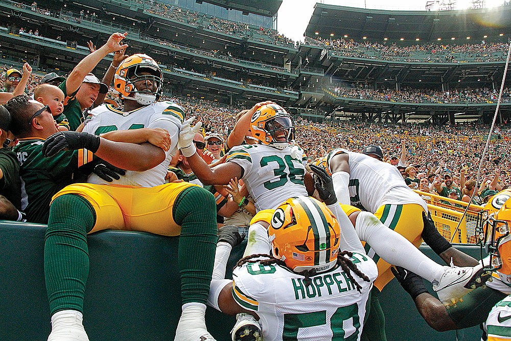 Green Bay Packers safety Anthony Johnson Jr. leaps into the stands after scoring a defensive touchdown during the second quarter of an NFL preseason game against the Baltimore Ravens at Lambeau Field Saturday, Aug. 24. (Jeremy Mayo/River News)