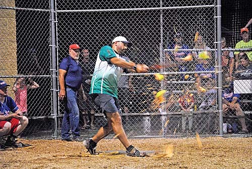 Jordan Schmidt of Dazzle’s Demons destroys the melon ball in the seventh inning of a 21-7 win over the Snowhawks Monday, Aug. 26 at Snowshoe Park in Lake Tomahawk. (Photo by Brett LaBore/Lakeland Times)