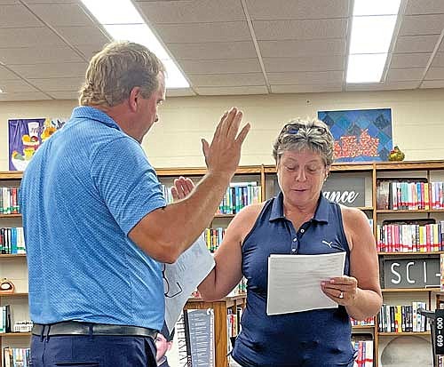 Ross Peterson is sworn-in by Heidi Fink to the Lakeland Union High School board of education during a meeting on Monday, Aug. 26, in Minocqua. (Photo by Trevor Greene/Lakeland Times)