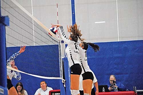 Ava Evenhouse, left, and Marlee Strasburg block an attack in the third set against Northland Pines Thursday, Sept. 5 at Northland Pines High School in Eagle River. (Photo by Brett LaBore/Lakeland Times)