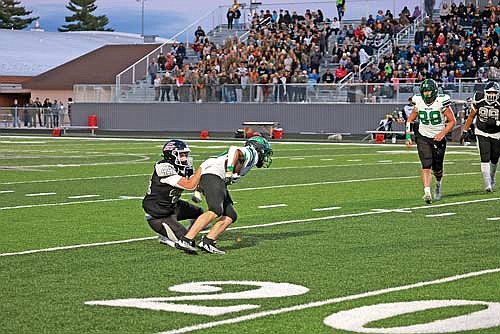 Michael Schettino tackles Rhinelander’s Cyrus Leisure in the conference opener Friday, Sept. 6 at IncredibleBank Field in Minocqua. (Photo by Bob Mainhardt for the River News)