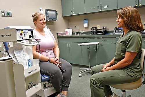 Dr. Joelle Wennlund, MD, obstetrics and gynecology, right, talks with Kaitlyn Van Natta, RN, near a loop electrosurgical excision procedure (LEEP) machine, left, which is used to treat abnormal or cancerous cells in women. (Contributed photograph)