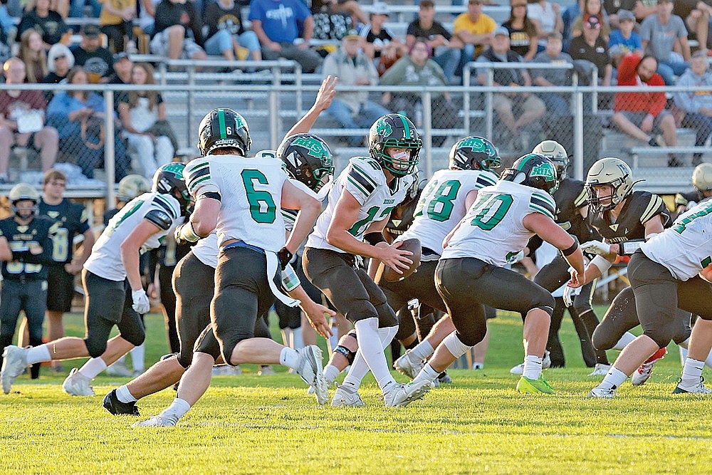 Rhinelander quarterback Truman Lamers takes a snap during the first quarter of a non-conference football game at Hayward Friday, Aug. 30. Lamers, who has been out since the end of the first quarter of that game due to an eye injury, is on track to make his return tonight as the Hodags get set to take on Wausau East in GNC play at Mike Webster Stadium. (Bob Mainhardt for the River News)