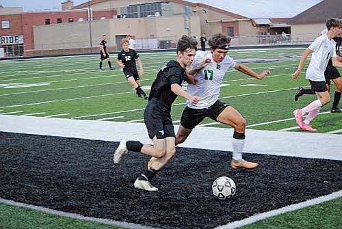 Cam Bernard, left, battles for possession of the ball with Rhinelander’s Karter Massey in the first half Thursday, Sept. 12 at IncredibleBank Field in Minocqua. (Photo by Brett LaBore/Lakeland Times)