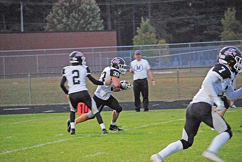 Deklan McQuade hands the ball off to Noah Bruckner in the first quarter against Mosinee Friday, Sept. 13 at Veterans Park in Mosinee. Bruckner scored from a yard out for Lakeland’s only touchdown of the game. (Photo by Brett LaBore/Lakeland Times)