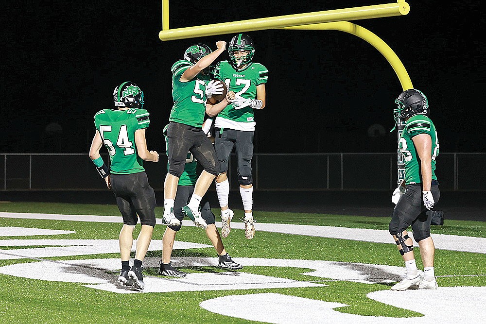 Rhinelander’s Abe Gretzinger (17) celebrates in the air with teammate Leander Sprecksel after scoring a touchdown during the third quarter of a GNC football game against Wausau East at Mike Webster Stadium Friday, Sept. 13. The Hodags outscored Wausau East 22-0 in the second half and defeated the Lumberjacks 28-7. (Bob Mainhardt for the River News)