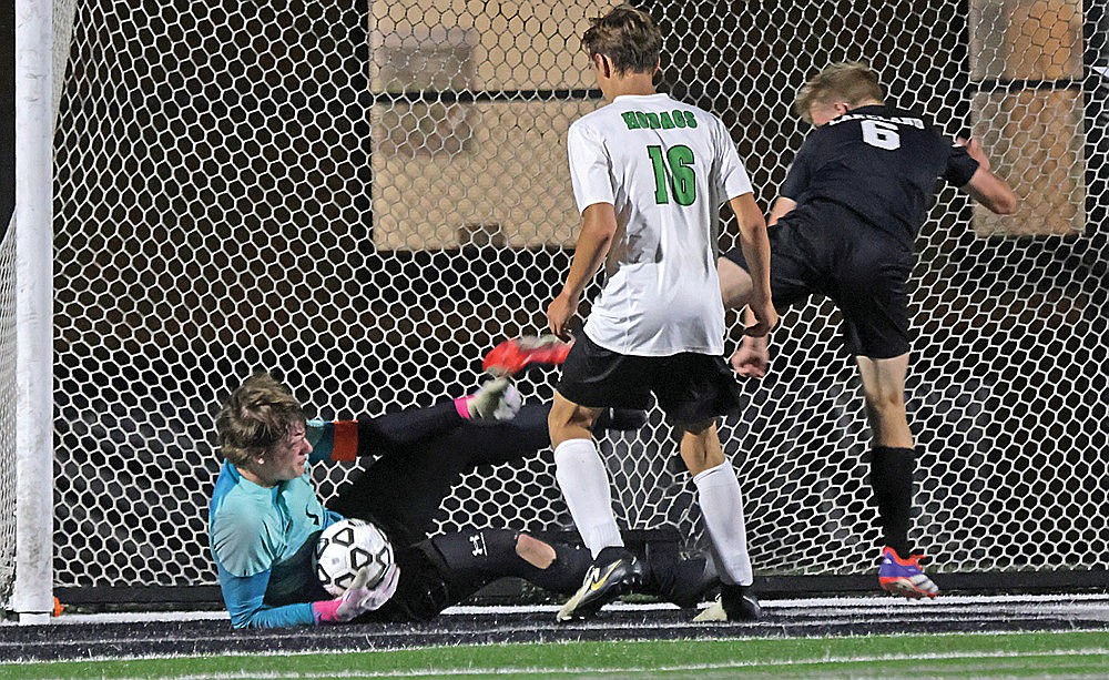 Rhinelander goalkeeper Barak Rappley tumbles to the ground to make a save after getting kneed in the head by Lakeland’s Jack Stepec (6) during the second half of a GNC boys’ soccer game in Minocqua Thursday, Sept. 12. Rappley left the game with a cut above the eyebrow as the Hodags eventually fell to the T-Birds, 3-0. (Jeremy Mayo/River News)